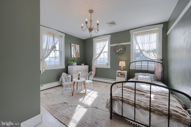 bedroom with a baseboard heating unit, a chandelier, visible vents, and multiple windows