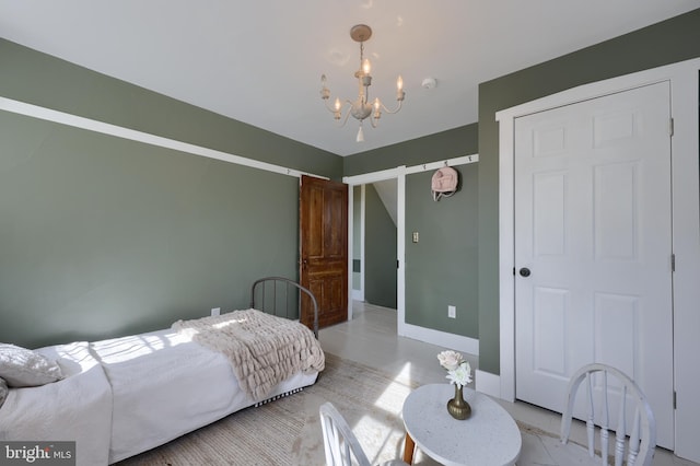 bedroom featuring a chandelier, concrete flooring, and baseboards