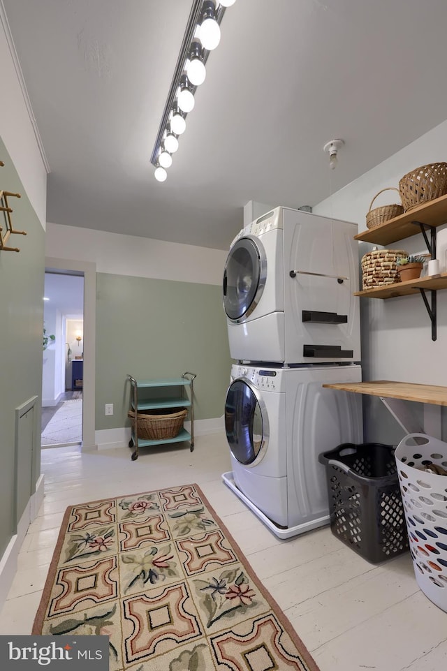 laundry area featuring laundry area and stacked washer / drying machine