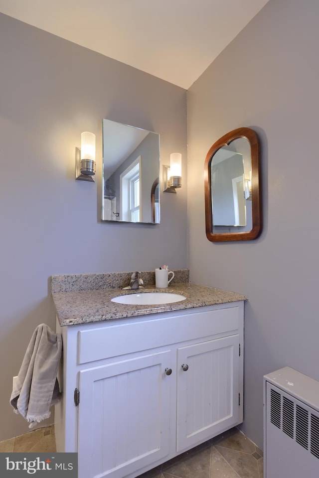 bathroom with vanity and radiator heating unit