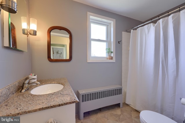 full bathroom featuring toilet, a shower with shower curtain, vanity, tile patterned floors, and radiator