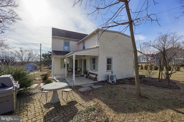 rear view of house featuring a patio area and ac unit