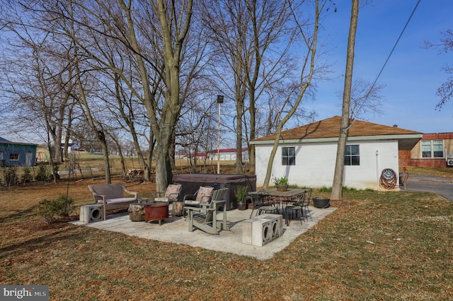 view of yard with a patio area and a hot tub