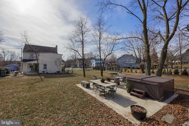 view of yard with a hot tub and a patio