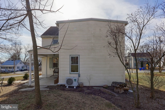 rear view of property featuring ac unit