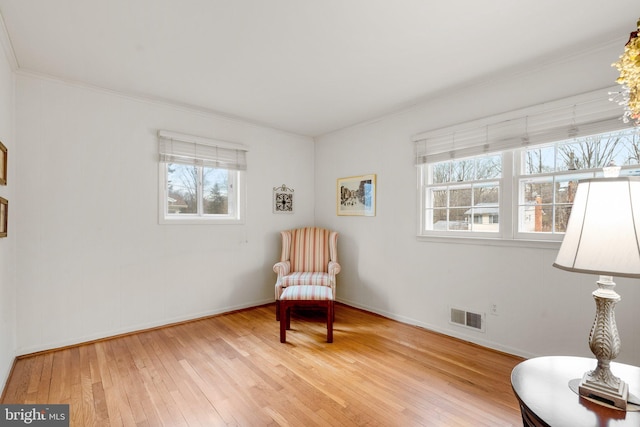 sitting room featuring a healthy amount of sunlight, visible vents, baseboards, and hardwood / wood-style flooring