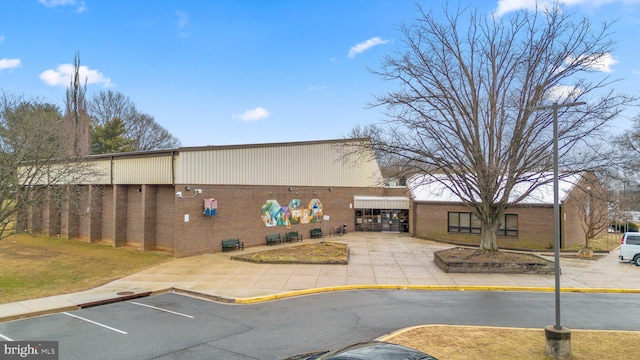 view of building exterior with uncovered parking