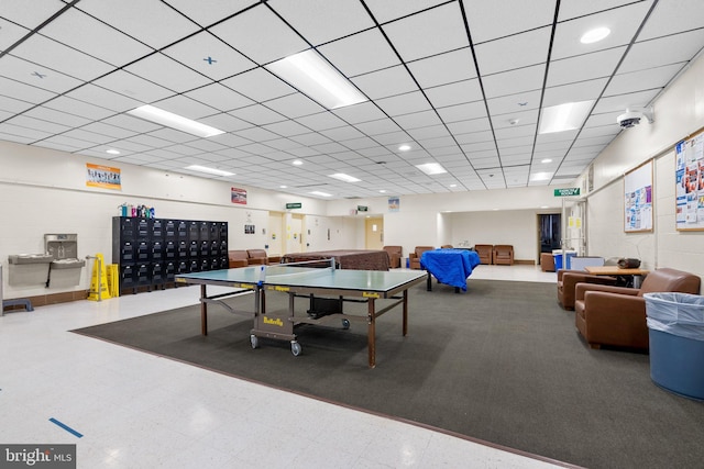 rec room with a paneled ceiling, mail area, and tile patterned floors