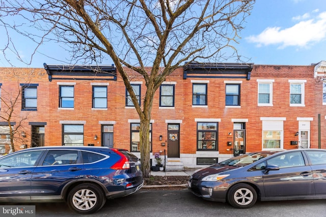 townhome / multi-family property featuring brick siding