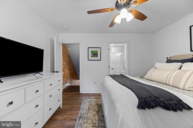 bedroom featuring dark wood-style floors, ensuite bathroom, a ceiling fan, and baseboards