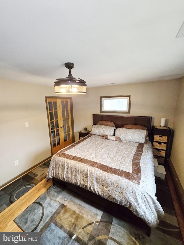 bedroom featuring french doors and baseboards