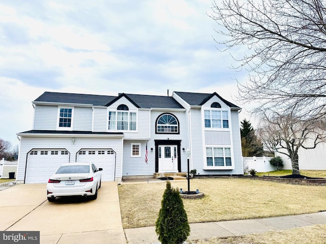 view of front facade with a garage, a front yard, fence, and driveway