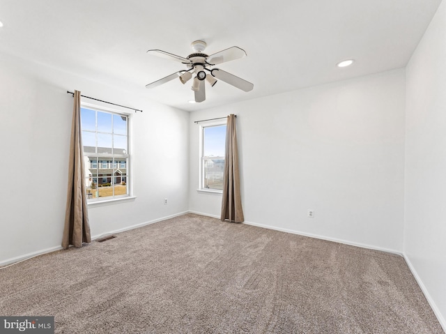 unfurnished room featuring ceiling fan, recessed lighting, carpet floors, visible vents, and baseboards