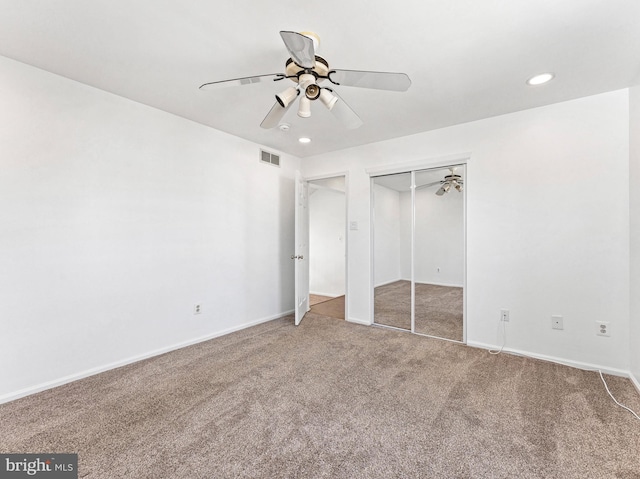 unfurnished bedroom with baseboards, visible vents, carpet, a closet, and recessed lighting