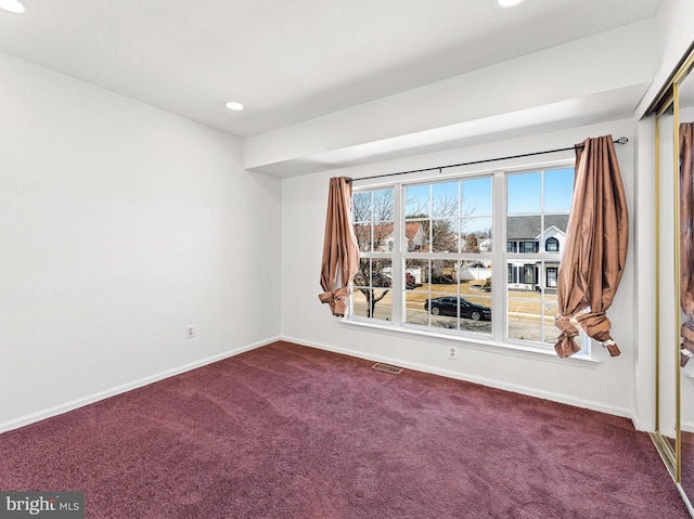 unfurnished room with carpet floors, recessed lighting, visible vents, and baseboards