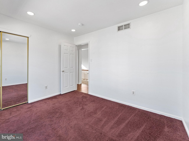 unfurnished bedroom featuring carpet floors, recessed lighting, visible vents, and baseboards