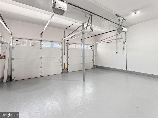 garage with baseboards and a garage door opener