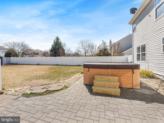 view of patio / terrace featuring a hot tub and a fenced backyard