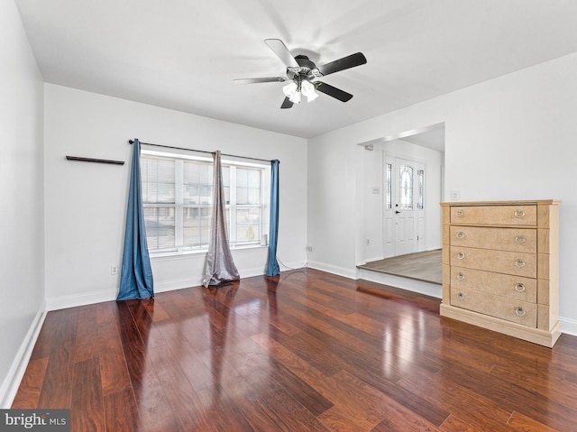 unfurnished bedroom featuring ceiling fan, baseboards, and wood finished floors