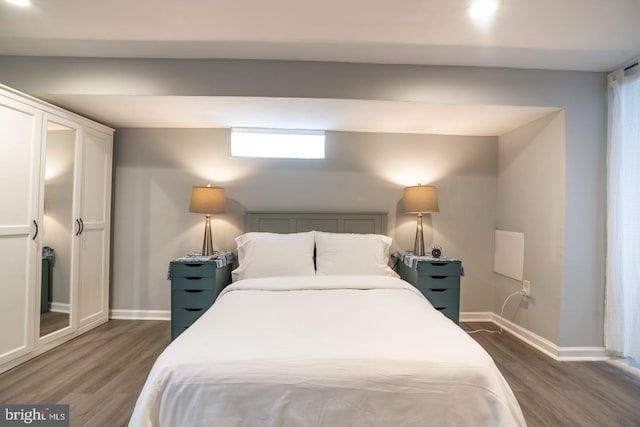 bedroom featuring wood finished floors and baseboards