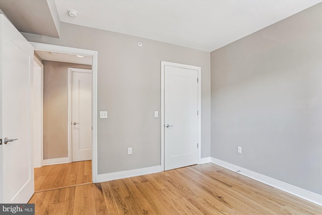 unfurnished bedroom featuring baseboards and light wood finished floors