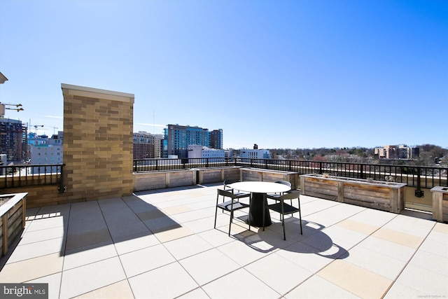 view of patio / terrace with a view of city and outdoor dining space