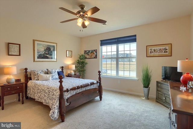 bedroom with ceiling fan, baseboards, and light colored carpet