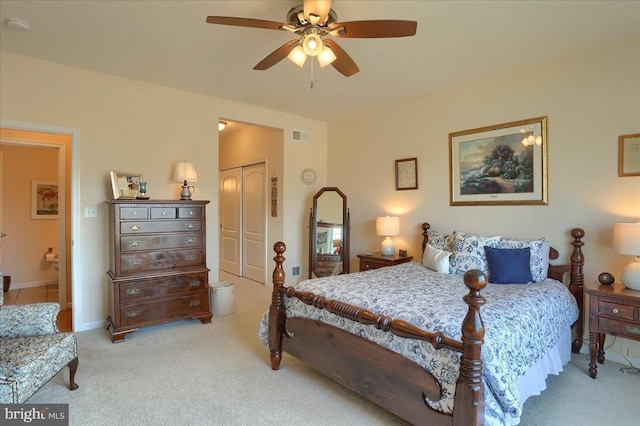 bedroom with light carpet, visible vents, baseboards, a ceiling fan, and a closet