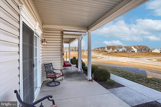 view of patio with a residential view and a porch