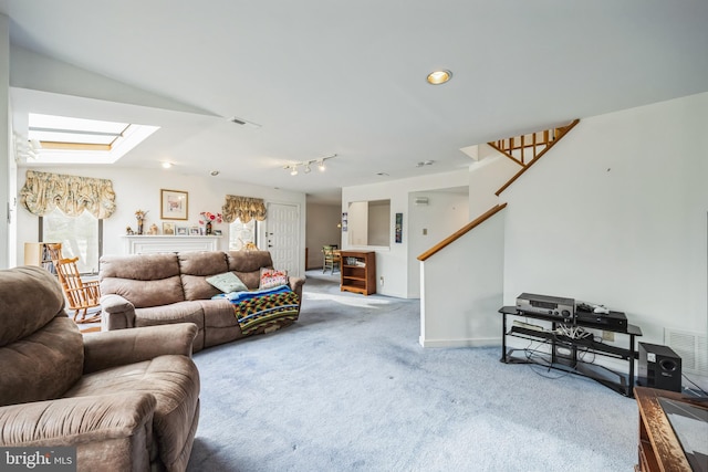 carpeted living area with a skylight, visible vents, stairway, and baseboards