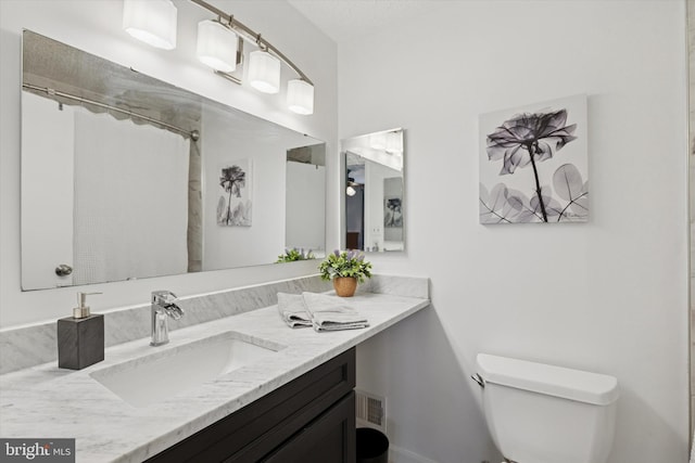 bathroom featuring visible vents, a shower with shower curtain, vanity, and toilet