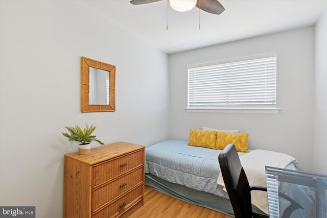 bedroom with a ceiling fan and light wood-style flooring