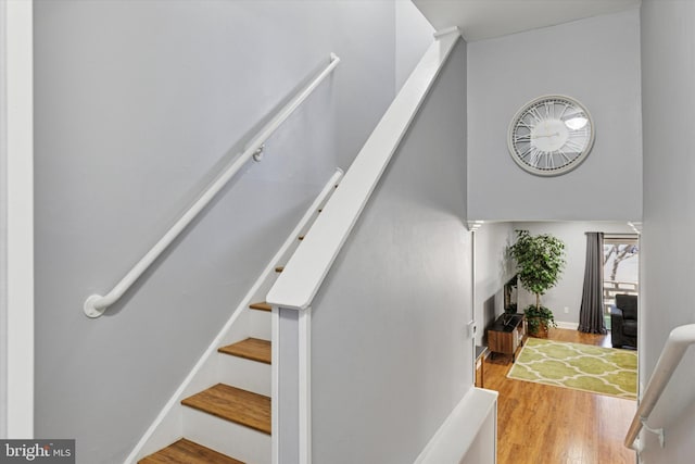 stairs featuring wood finished floors