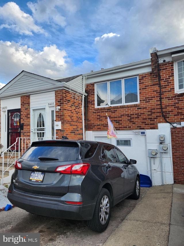 townhome / multi-family property with brick siding