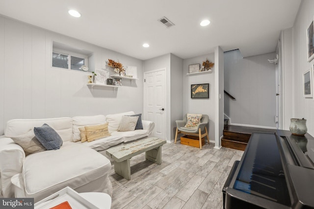 living room featuring recessed lighting, stairway, visible vents, and light wood finished floors