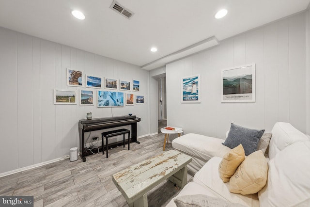 living room featuring recessed lighting, wood finished floors, and visible vents