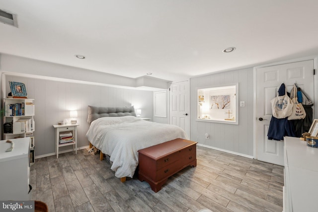 bedroom with recessed lighting, visible vents, baseboards, and wood finished floors