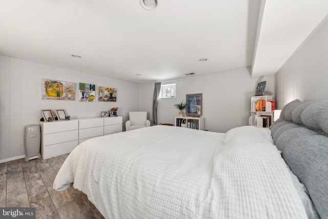 bedroom with wood finish floors