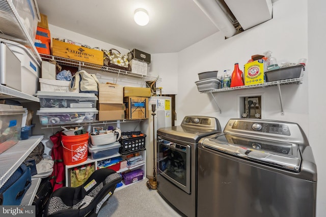 laundry area with separate washer and dryer, laundry area, and water heater