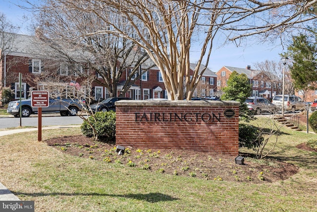 community sign with a lawn and a residential view