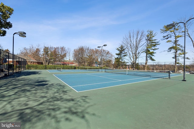 view of tennis court with fence