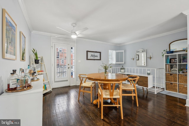 dining space with wood-type flooring, ornamental molding, and a ceiling fan