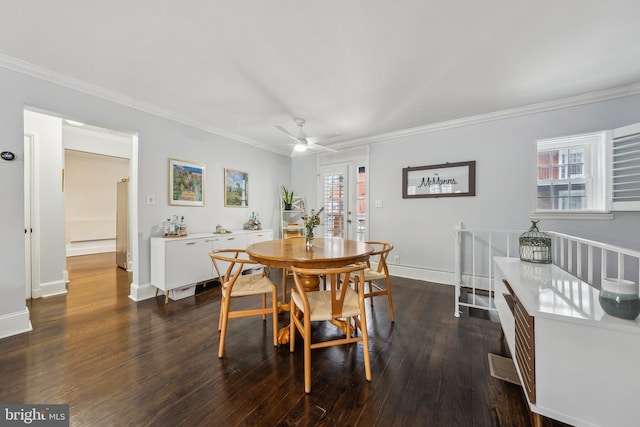 dining area with baseboards, wood-type flooring, ceiling fan, and crown molding