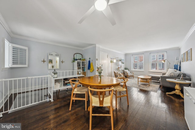 dining space with wood-type flooring and crown molding