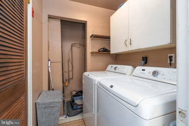 laundry room with cabinet space and washing machine and dryer