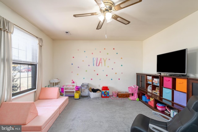 rec room featuring carpet floors, visible vents, and ceiling fan