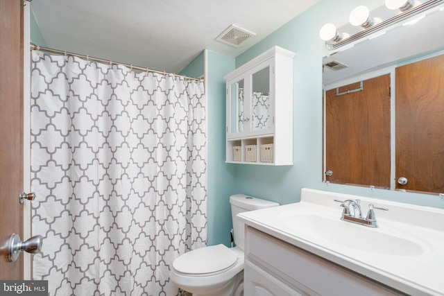 bathroom with toilet, curtained shower, vanity, and visible vents