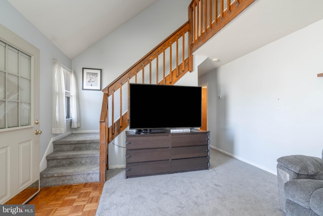 living area featuring stairs, vaulted ceiling, carpet flooring, and baseboards