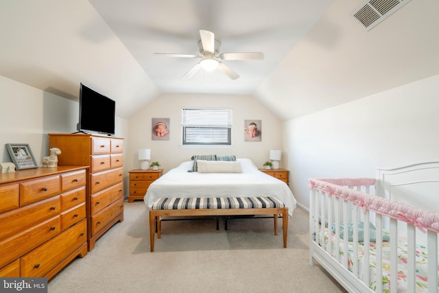 bedroom with vaulted ceiling, light carpet, visible vents, and a ceiling fan