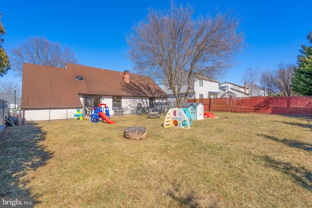 view of yard with a playground and fence